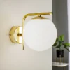 Aplique de pared Aurora, dorado, cristal, 17 cm de alto, esférico, E14