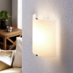 Aplique de pared LED Lindby Helmi, altura 21 cm, cristal, semicircular