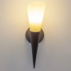 Aplique de pared Lindby Alva, color óxido, cristal, 34 cm de altura, E14