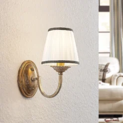 Aplique de pared Lindby Lumiel, crema/latón, textil, 27cm
