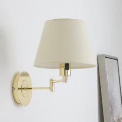 Aplique de pared Lindby Pola, 30 cm, latón, extensible, tela