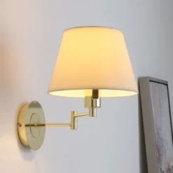 Aplique de pared Lindby Pola, 30 cm, latón, extensible, tela