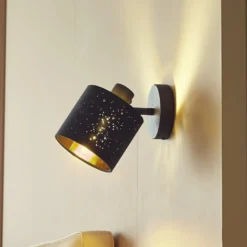 Aplique de pared Lindby Vasilia, Ø 12 cm, negro/oro, tela
