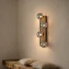 Aplique de pared Lindby Woodora, madera, vidrio, gris humo, 4 luces
