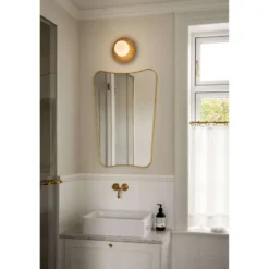 Aplique de pared Nuura Liila Muuse, Ø 20 cm, IP44, dorado/ópalo