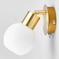 Foco de pared Lindby Elaina, color latón, cristal, 14 cm de altura, E14