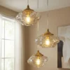 Lámpara colgante Lindby Piatra, Ø25cm, 3 luces, coñac/latón, cristal
