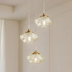 Lámpara colgante Lindby Piatra, Ø25cm, 3 luces, coñac/latón, cristal