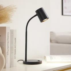 Lámpara de mesa Lindby Radka, negra, plástico, brazo flexible