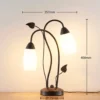 Lámpara de mesa Lindby Stefania, negro/oro, cristal, E14, 40 cm