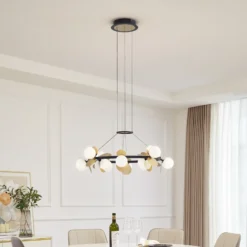 Lucande Lámpara colgante LED Pallo, 12 luces, negro/oro, cristal
